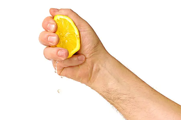 male hand squeezing lemon