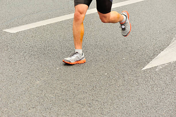 istock marathon runner athlete  running on city road 529235437