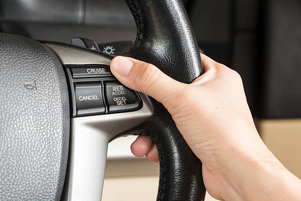 control cruise button control cruise button On the steering wheel control stock pictures, royalty-free photos & images