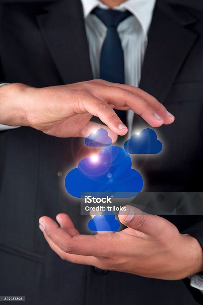 Close-up of a businessman securing cloud computing Holding Cloud Adult Stock Photo