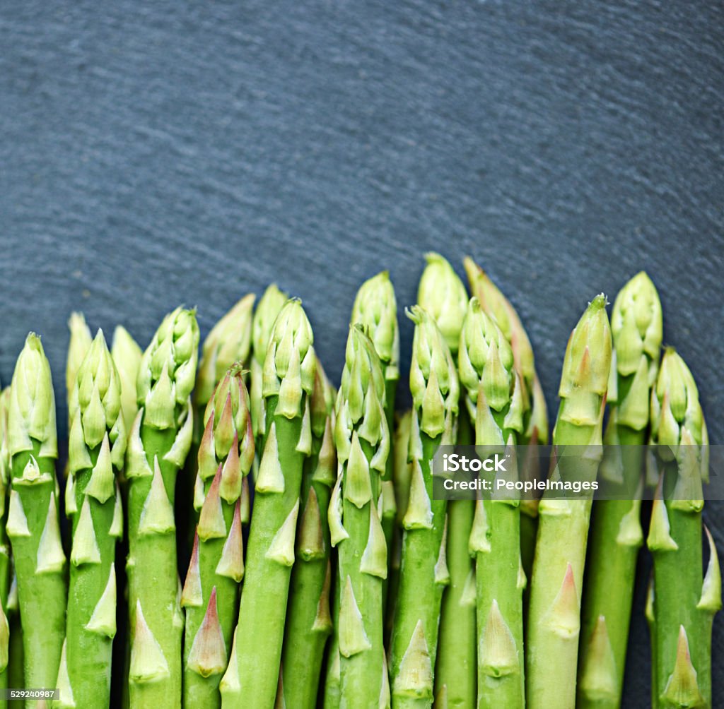 Healthy green spears Shot of fresh asparagus spread out on a tabletop Antioxidant Stock Photo