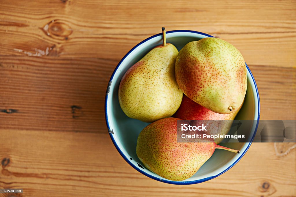 Fruity delights Shot of a bowl of pears on a kitchen table Antioxidant Stock Photo