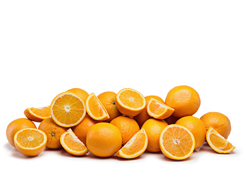 Studio shot of a pile of juicy oranges against a white background