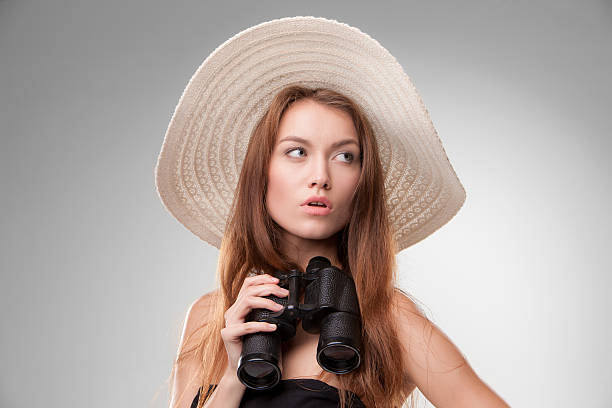 istock Young woman in hat with binoculars 529254891
