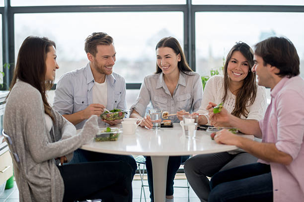 istock Happy friends eating together 529255221