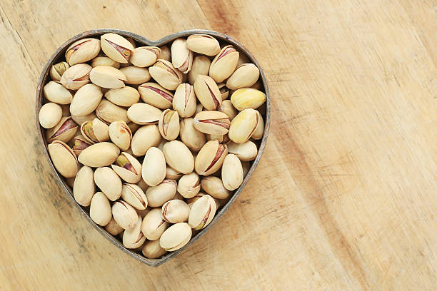istock Pistachio nuts in heart shape 529274345