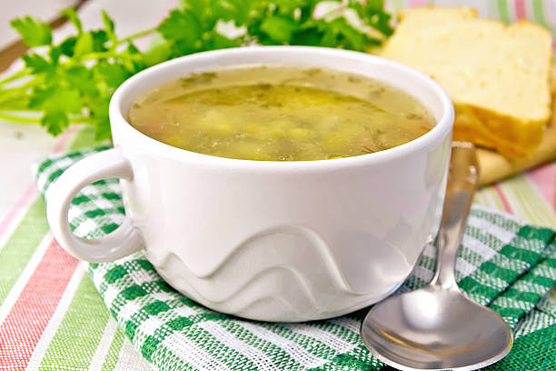 istock Soup of green peas with bread on tablecloth 529275055