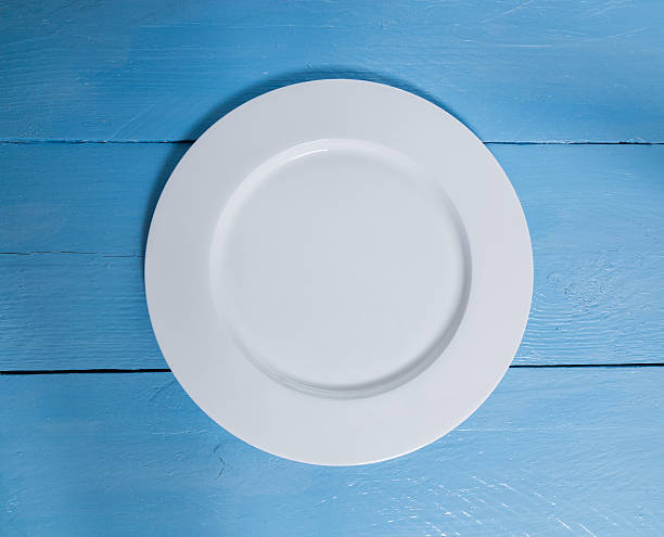 istock Empty plate on blue wooden background 529275869