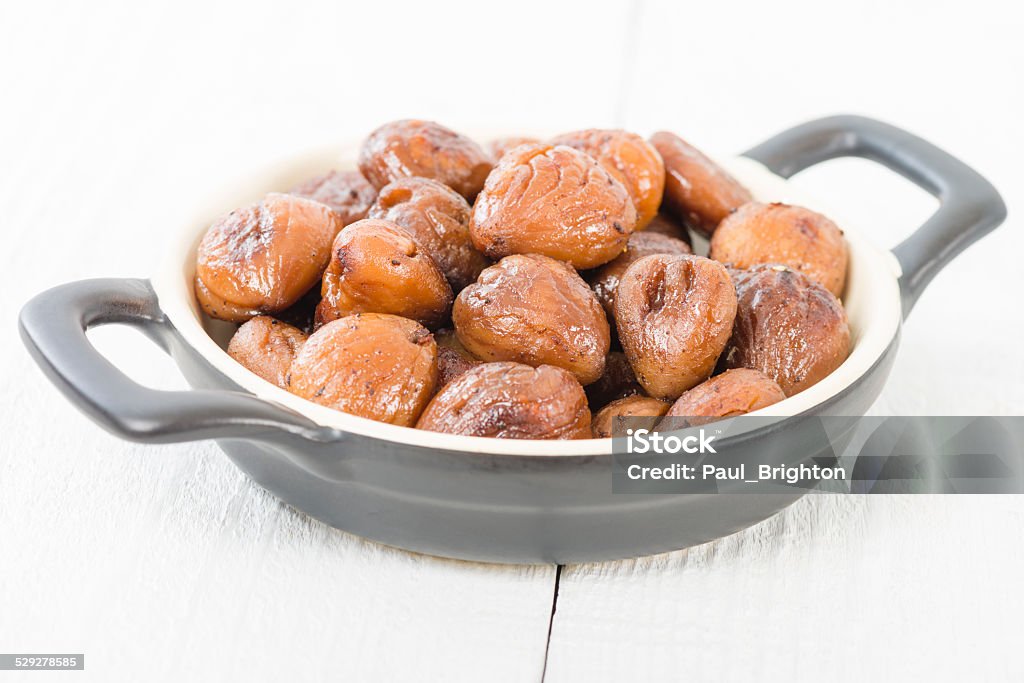 Chestnuts Peeled and cooked chestnuts on a white background. Black Color Stock Photo