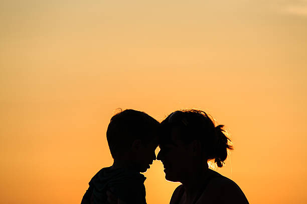 istock mother and son at sunset beach 529312547