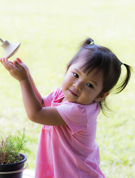 istock Cute little girl is playing old shower 529312573