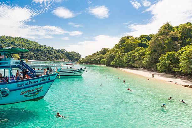 Koh Chang in Thailand Koh Chang, Thailand - November 12 2014: Tourists enjoy the beach and swimming in a remote island (Koh Muk) near Koh Chang in Thailand koh chang stock pictures, royalty-free photos & images