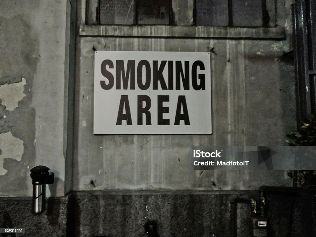 Grunge Notice Smoking Area A grunge area and sign of smoking free zone Addiction Stock Photo