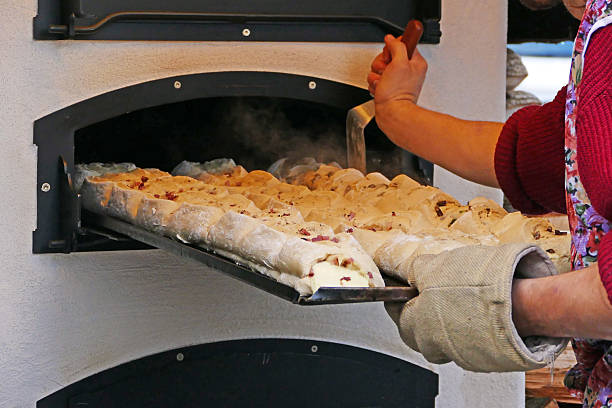 Raw loaf of bread from wheaten flour being baked in the oven
