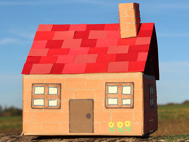 istock Image of cardboard dolls house, with field, tree and sky 529314817