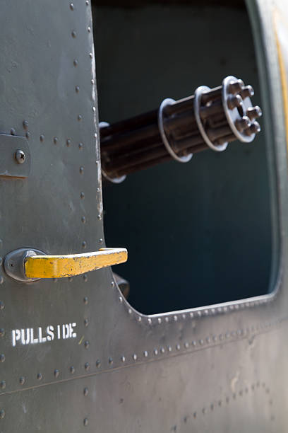 istock Machine gun pointing out from the door opening 529315707