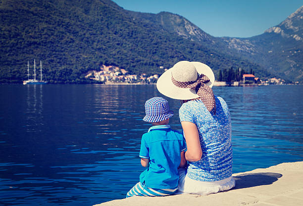 istock mother and son looking at scenic sea view 529316867