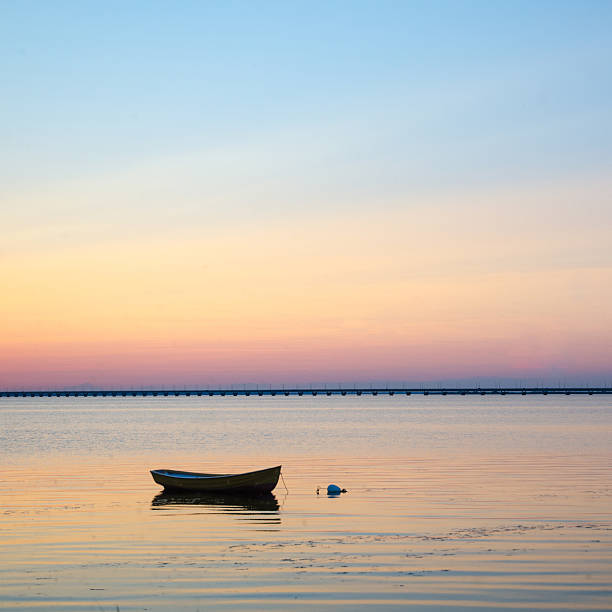 istock Anchored rowboat at sunset 529327257