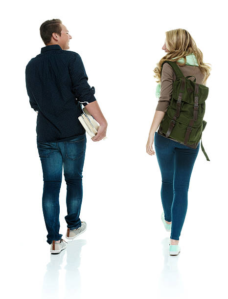 istock Rear view of two students walking 529328537