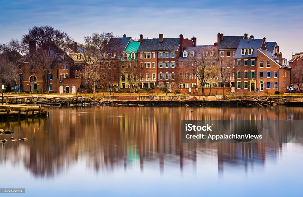 Reflections of waterfront buildings along the Potomac River in A Reflections of waterfront buildings along the Potomac River in Alexandria, Virginia. Apartment Stock Photo