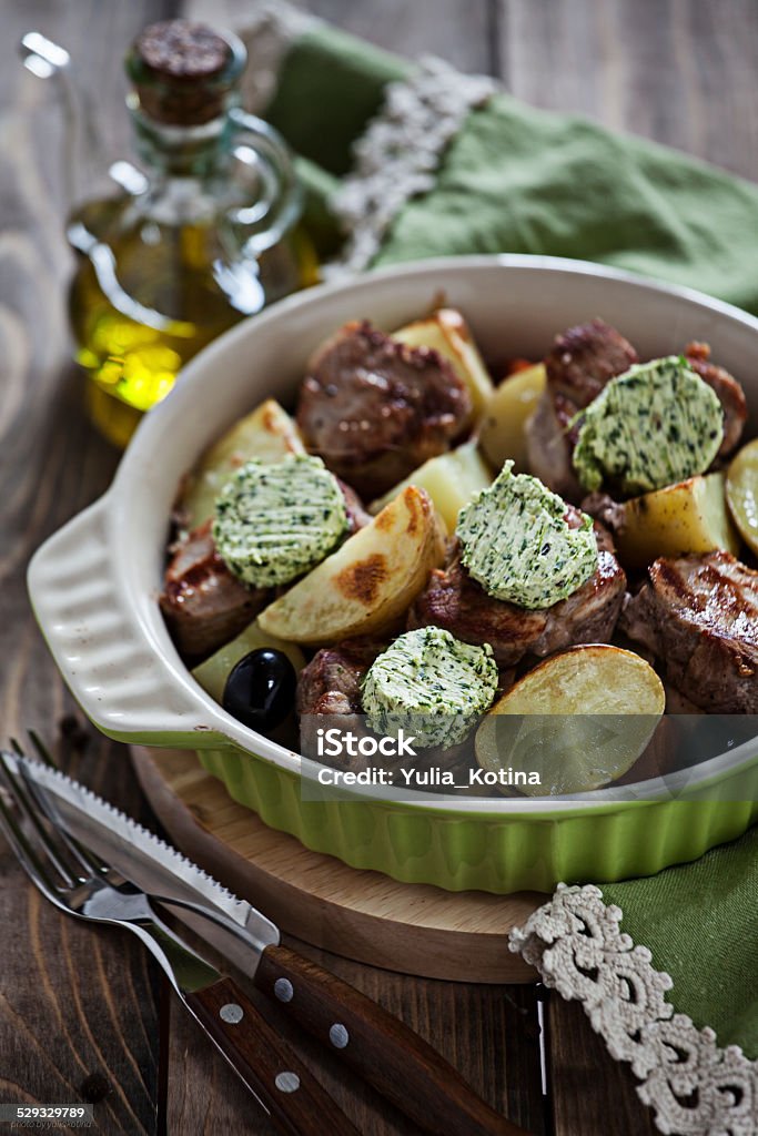 Pork tenderloin Baked pork tenderloin with vegetables and green butter Butter Stock Photo