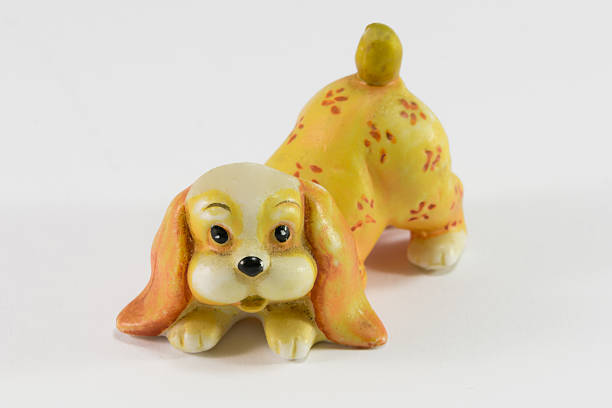 istock Statuette of dog sitting on white background 529329907