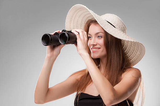 istock Young woman in hat with binoculars 529330345