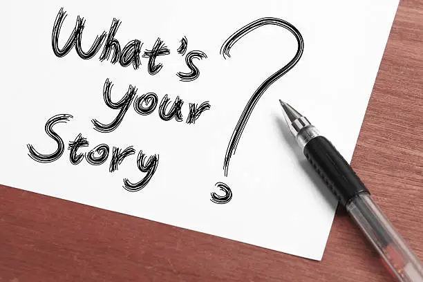 â Whats Your Storyâ Concept written on white paper with black ballpen aside.