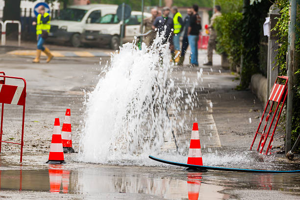 istock road spurt water beside traffic cones 529357167