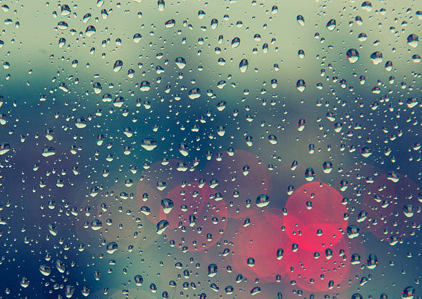 istock rain drops on the window with traffic bokeh light 529364841