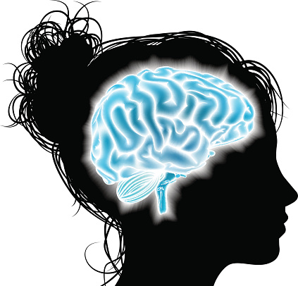 A womans head in silhouette with a glowing brain. Concept for mental, psychological development, brain development, mental stimulation,  learning and education or other medical theme