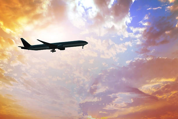 istock airplane in the sunset sky 529369923