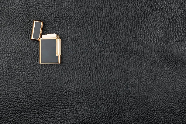 Gold Lighter lies on natural leather