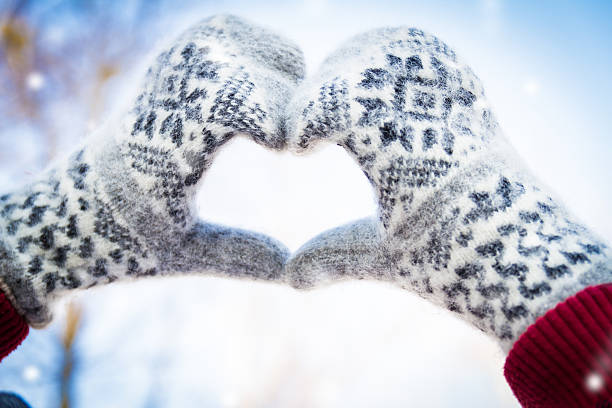 istock mittens heart on winter background 529381491