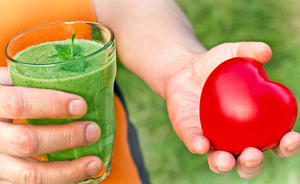 istock Healthy drink - green smoothie in hand 529382173