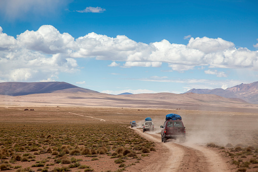 4wd car driving with dusty on lava field icelandic highlands in summer at Landmannalaugar, Iceland