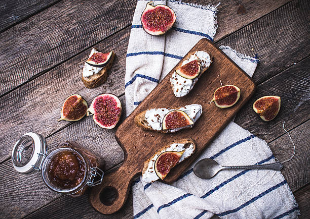 istock Bruschetta snacks with cut figs on napkin in rustic style 529383963