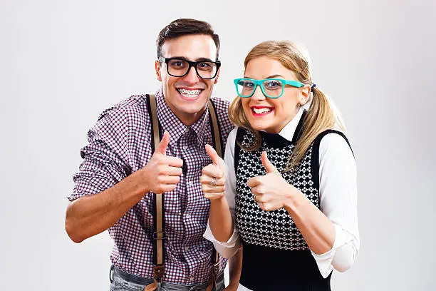 Happy nerdy couple showing thumbs up.
