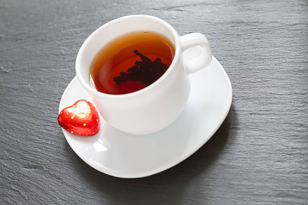 istock Black tea and heart shaped red chocolate 529385723