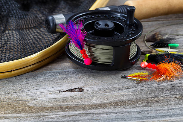 istock Close up of Fly Reel with jig hanging from spool 529385957