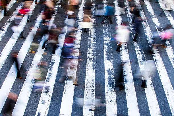 istock People crossing a zebra crossing 529399384