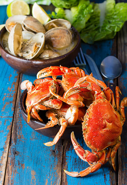 istock Seafood. Crabs in clay bowl and clams soup 529399486
