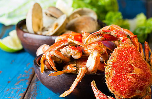 istock Seafood. Crabs in clay bowl and clams soup 529399558