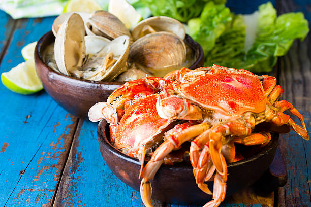 istock Seafood. Crabs in clay bowl and clams soup 529399604