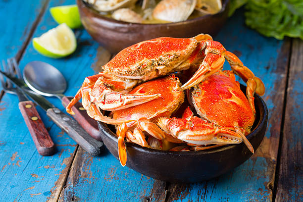 istock Seafood. Crabs in clay bowl and clams soup 529399724
