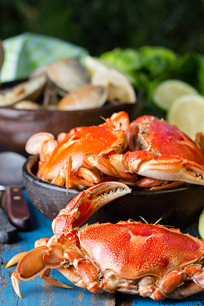 istock Seafood. Crabs in clay bowl on wooden background 529399792