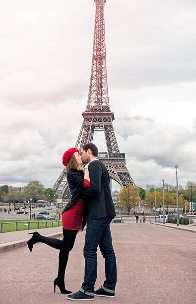 istock Young couple in love at Eiffel Tower 529399996