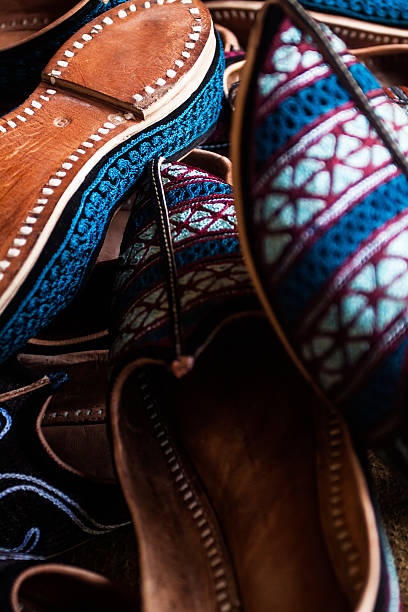 Arab women's white shoes made of natural silk embroidered with curled toes on isolated background.