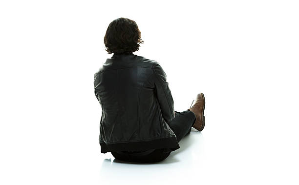 istock Rear view of man sitting on floor 529401680