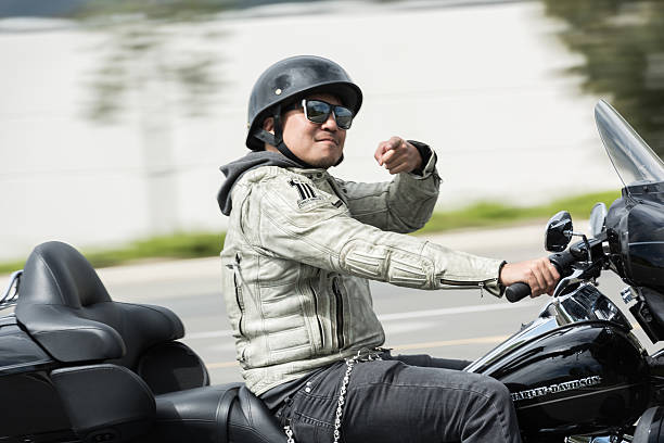City of Industry, United States - March 10, 2016: Motorcycle biker joy riding and pointing directly into the camera